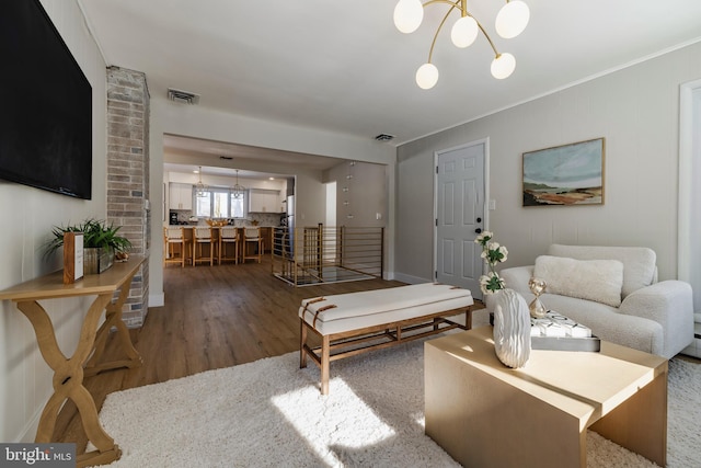 living room featuring dark hardwood / wood-style flooring and a notable chandelier