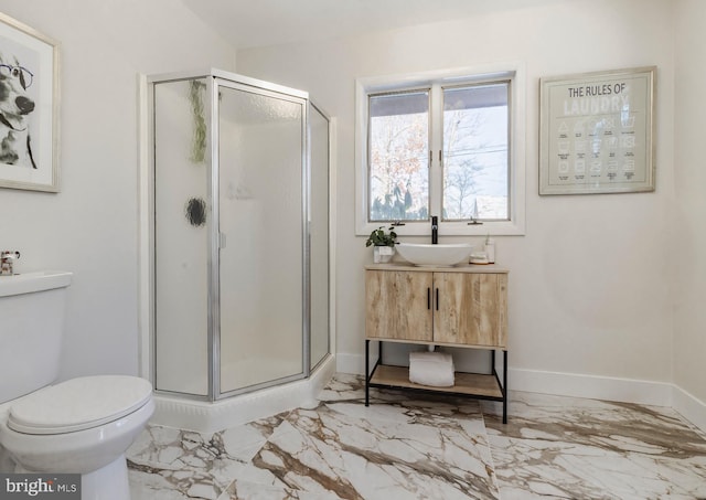 bathroom with vanity, toilet, and an enclosed shower