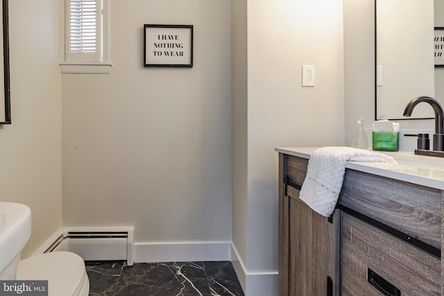 bathroom with baseboard heating, vanity, and toilet