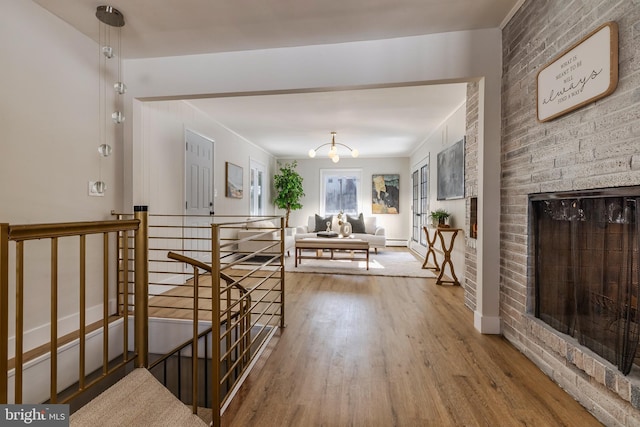 hallway with hardwood / wood-style floors and an inviting chandelier