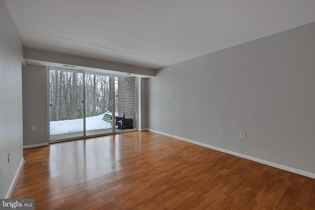 unfurnished room with hardwood / wood-style floors