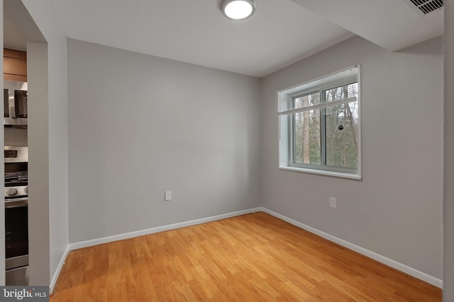 spare room with light hardwood / wood-style floors