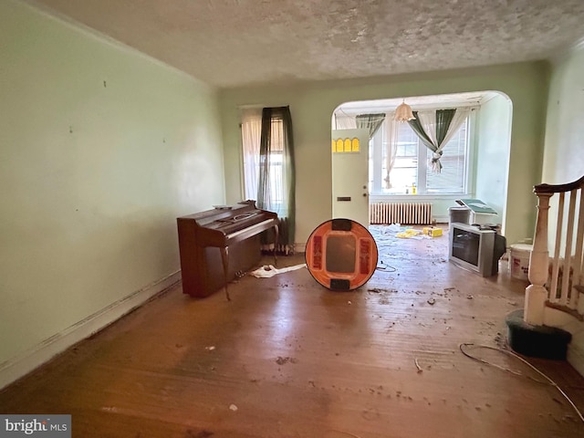 misc room featuring a textured ceiling and radiator heating unit