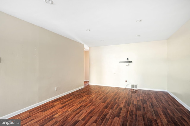 spare room featuring dark wood-type flooring