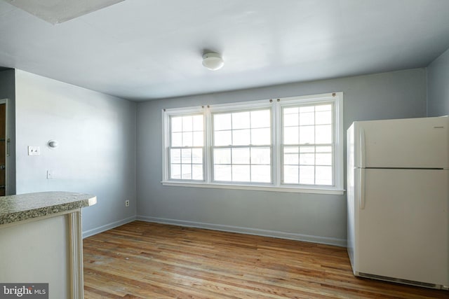 unfurnished dining area with light hardwood / wood-style floors