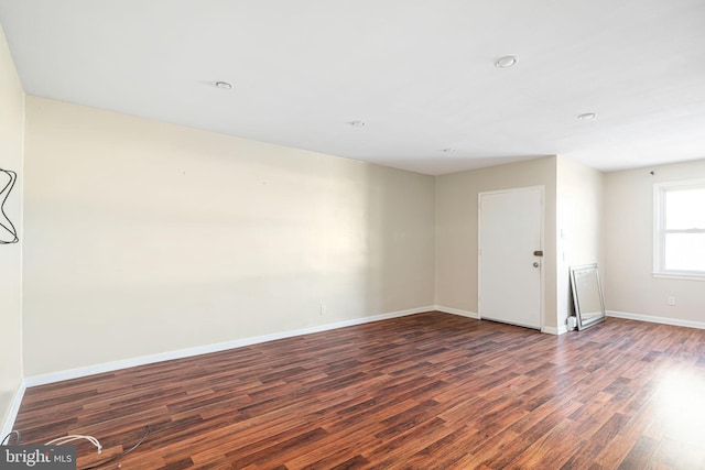 spare room featuring dark wood-type flooring