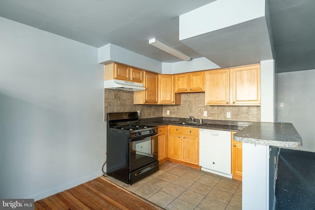 kitchen featuring black gas range, white dishwasher, sink, decorative backsplash, and light tile patterned floors