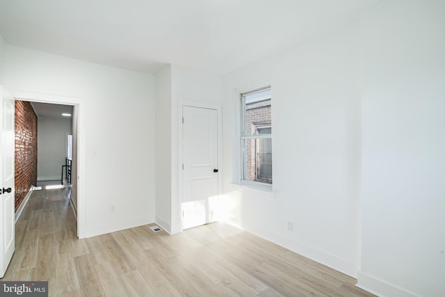 unfurnished room with light wood-type flooring