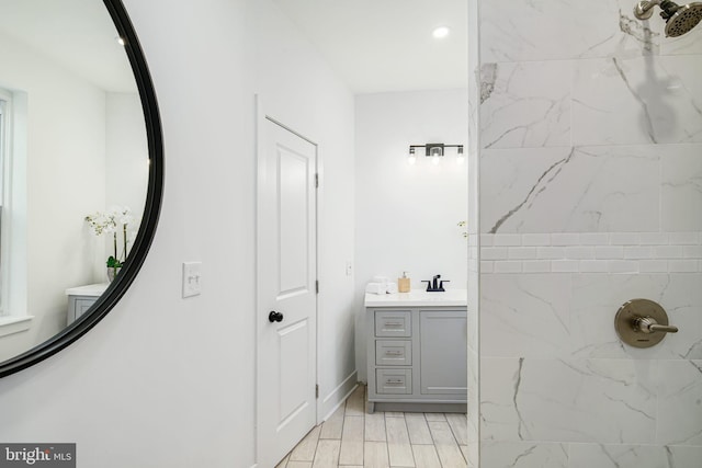 bathroom with vanity and tiled shower