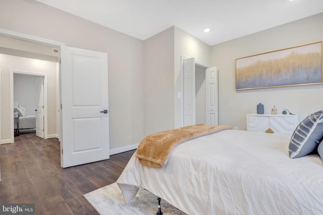 bedroom with dark wood-type flooring