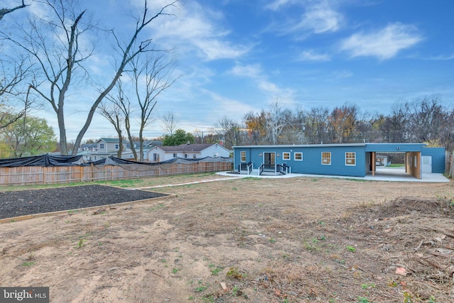 back of property with a patio