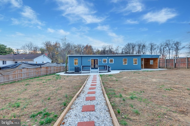 view of front of house with central AC, a patio, a front yard, and a deck