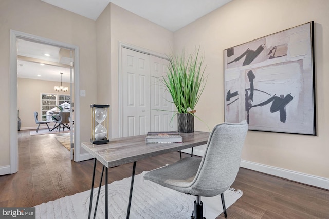 office area featuring dark wood-type flooring and a notable chandelier