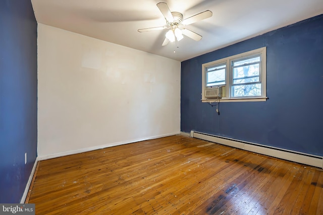 empty room featuring ceiling fan, hardwood / wood-style floors, and a baseboard heating unit