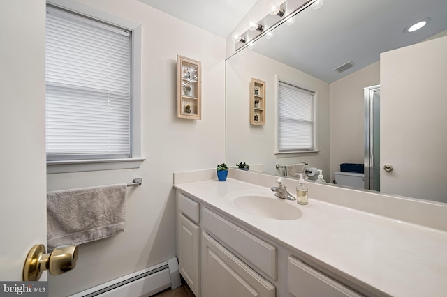 bathroom with toilet, visible vents, a baseboard radiator, and vanity
