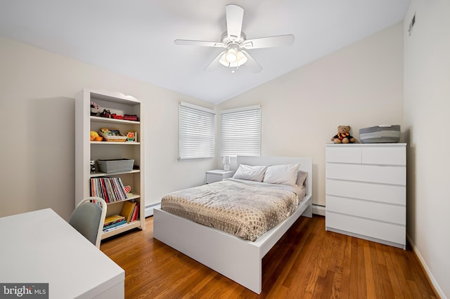 bedroom featuring ceiling fan, a baseboard radiator, vaulted ceiling, and wood finished floors