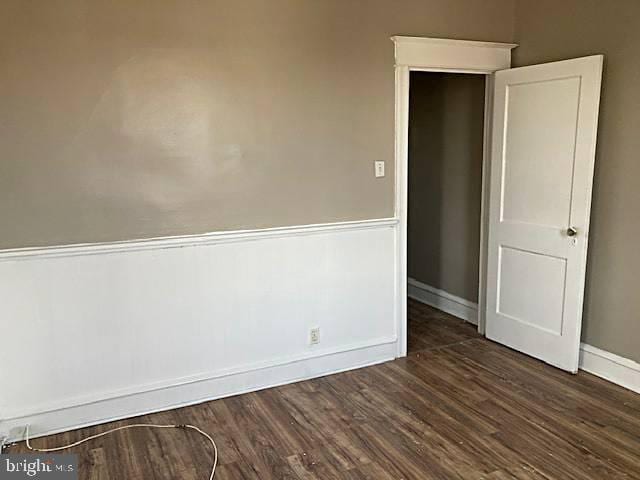 empty room featuring dark wood-type flooring