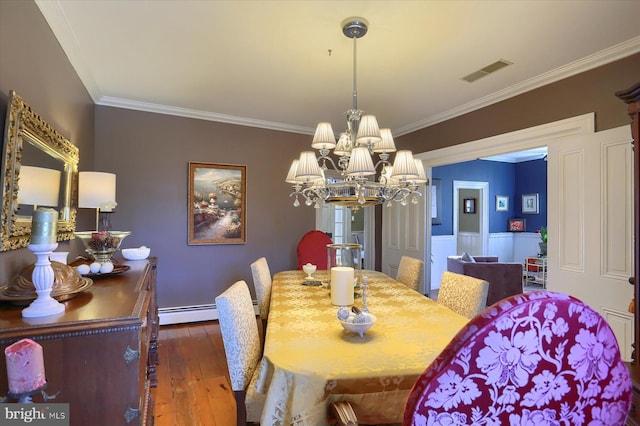 dining space featuring dark hardwood / wood-style flooring, a baseboard radiator, a notable chandelier, and ornamental molding