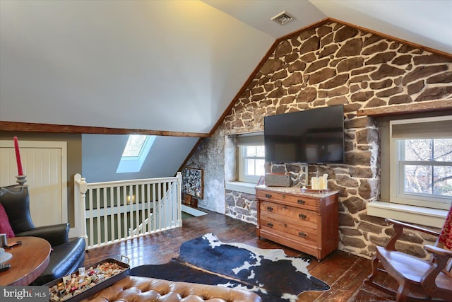 bedroom with lofted ceiling with skylight and dark wood-type flooring