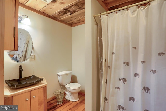 bathroom featuring a shower with shower curtain, vanity, wood-type flooring, wooden ceiling, and toilet