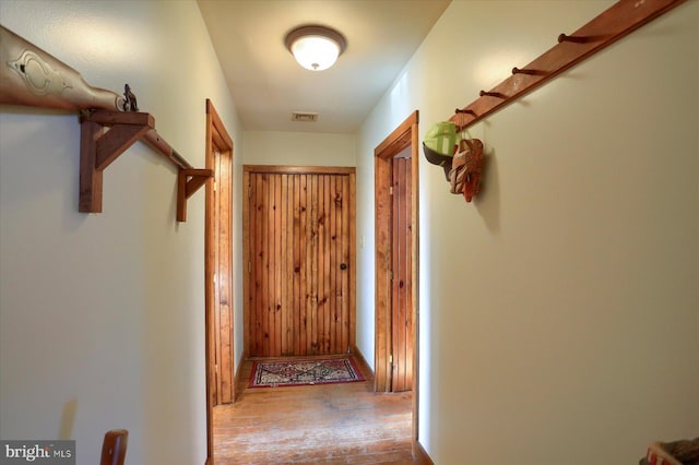 hallway with light hardwood / wood-style floors