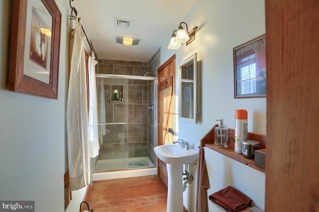 bathroom with sink and tiled shower