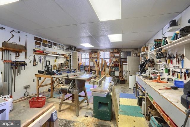 misc room featuring a workshop area and a drop ceiling