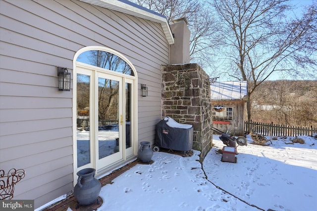 view of snow covered property entrance