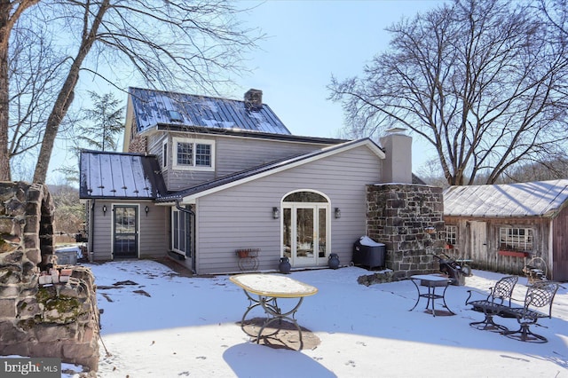 view of snow covered rear of property