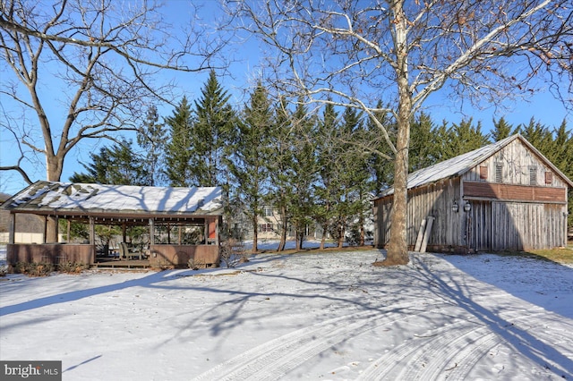 yard layered in snow with an outdoor structure