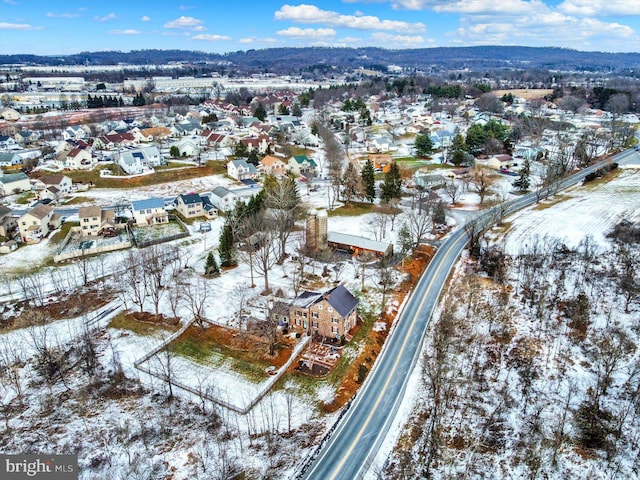 snowy aerial view with a mountain view