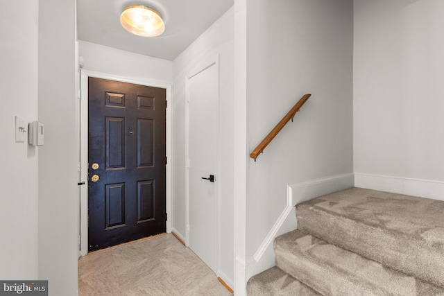 foyer featuring light carpet