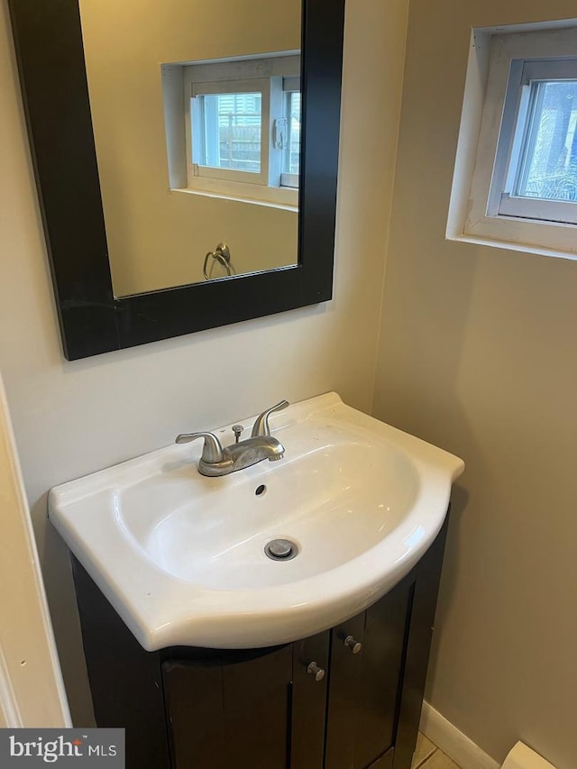 bathroom with plenty of natural light and vanity