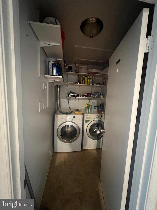 laundry area featuring separate washer and dryer and dark tile patterned floors