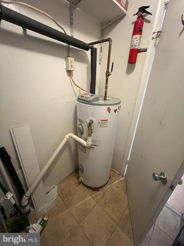 utility room featuring water heater