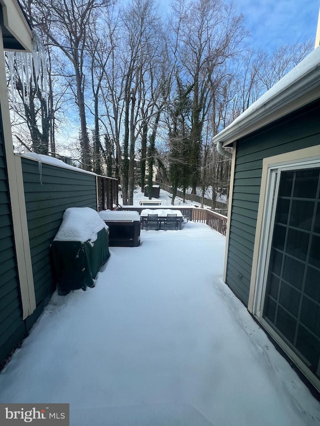 yard covered in snow featuring a deck