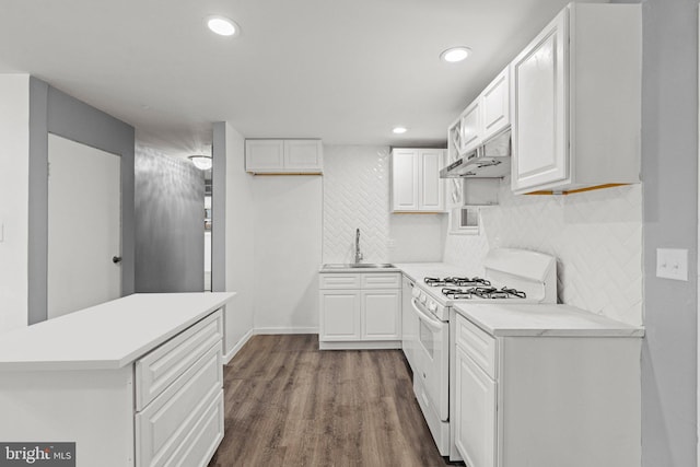 kitchen featuring white gas range oven, tasteful backsplash, white cabinetry, sink, and dark wood-type flooring