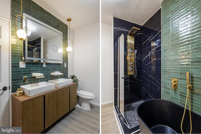 full bathroom featuring vanity, backsplash, toilet, shower with separate bathtub, and wood-type flooring