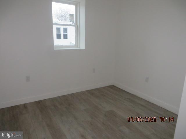 unfurnished room featuring wood-type flooring