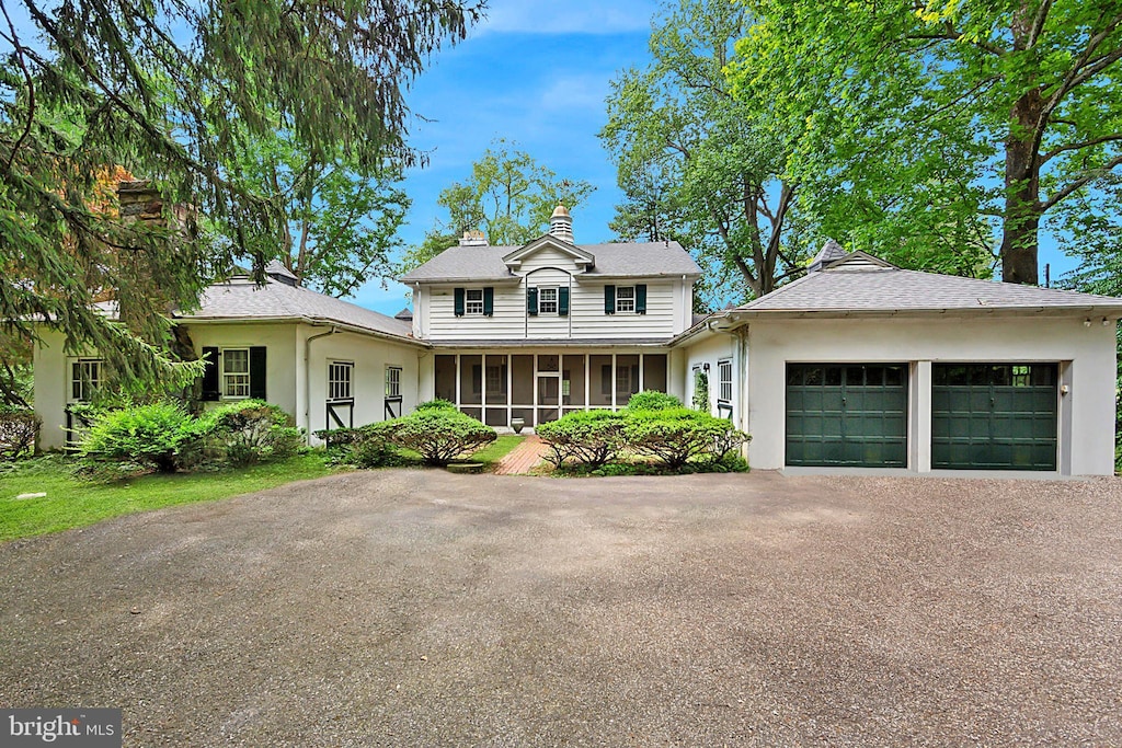 view of front facade featuring a sunroom and a garage