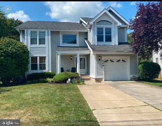 view of front of home featuring a garage and a front lawn