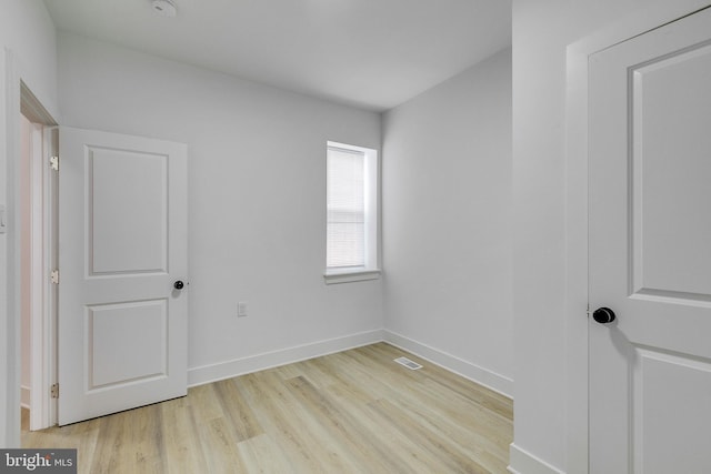 spare room with light hardwood / wood-style flooring