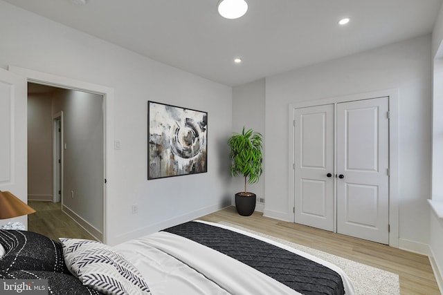 bedroom featuring a closet and light hardwood / wood-style flooring