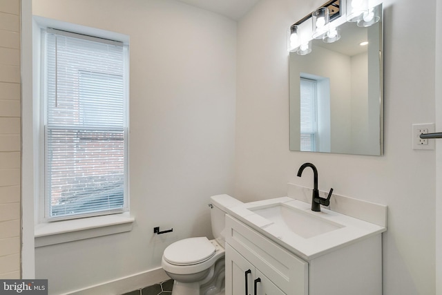 bathroom featuring tile patterned floors, vanity, and toilet