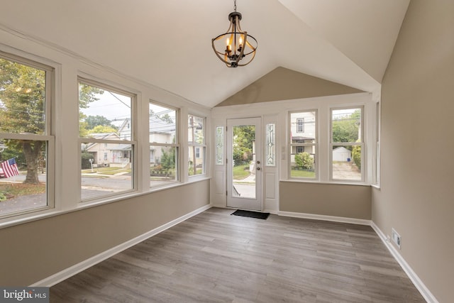 unfurnished sunroom with an inviting chandelier and lofted ceiling