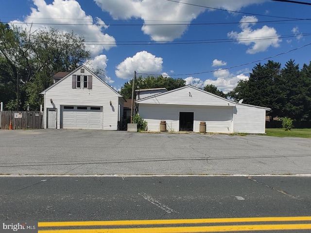 view of front of home with a garage and an outdoor structure