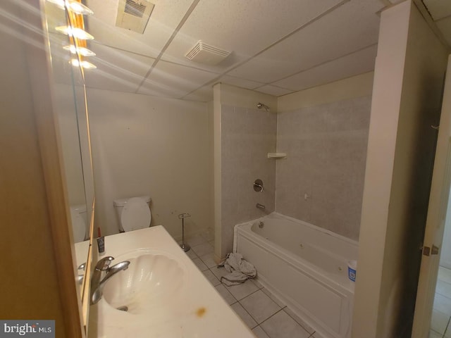 full bathroom with tiled shower / bath, tile patterned floors, toilet, and sink