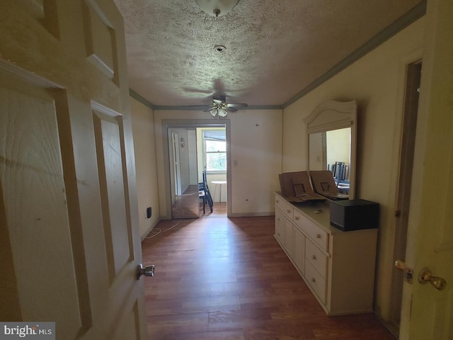 hall featuring wood-type flooring, ornamental molding, and a textured ceiling