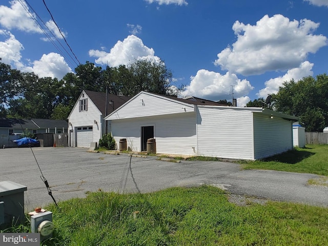 view of side of property featuring an outbuilding and a garage