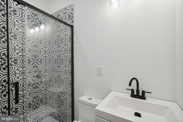 bathroom featuring a shower, vanity, and toilet